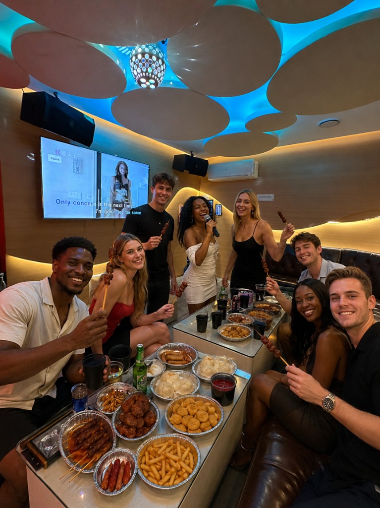 Friends enjoying karaoke, food and drinks in a Cosy Room at Level 8 KTV Manchester